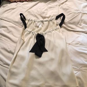 Cream blouse with black straps and bow